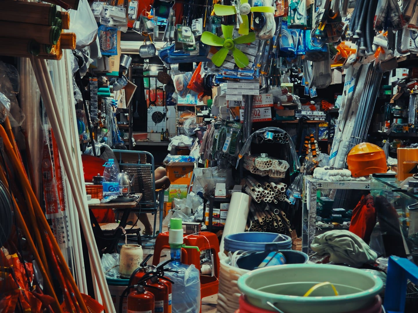 A crowded hardware store aisle filled with tools and supplies.